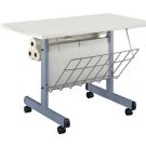 A mobile Laminating Workstation with a white tabletop, wire storage basket, and built-in roll holders on a sturdy metal frame with wheels.
