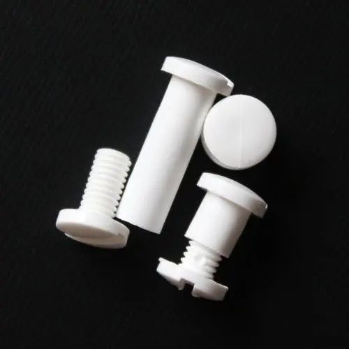 A set of 1/4" White Plastic Screw Posts with smooth, interlocking components, ideal for securing documents, swatch books, or lightweight materials, displayed against a black background.