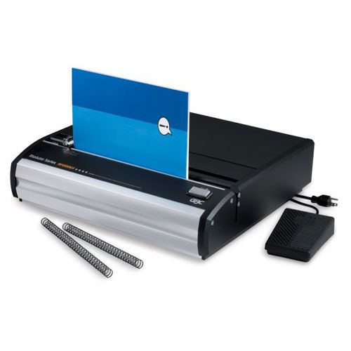 A GBC MP2000W3 Modular Series 3:1 Fixed Die Wire Binding Punch machine with a blue cover sheet and wire coils placed beside it.