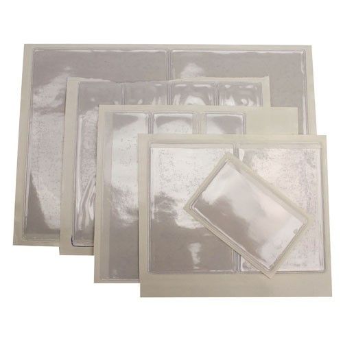 Assorted sizes of 3-1/2" x 4-1/2" Crystal Clear Adhesive Vinyl Pockets displayed in a stack, showing transparent protective covers with adhesive backing.