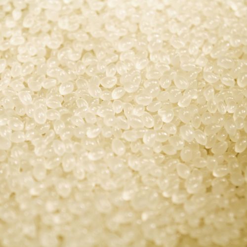 Close-up of Coverbind Premium Perfect Bind Adhesive in the form of small, translucent, white granules.