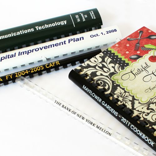 Several documents bound with custom-printed plastic combs.