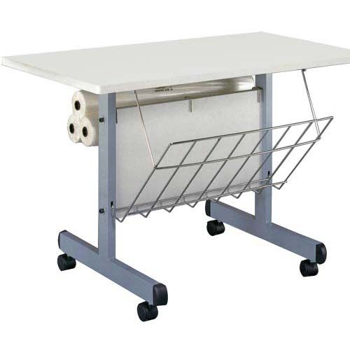 A mobile Laminating Workstation with a white tabletop, wire storage basket, and built-in roll holders on a sturdy metal frame with wheels.