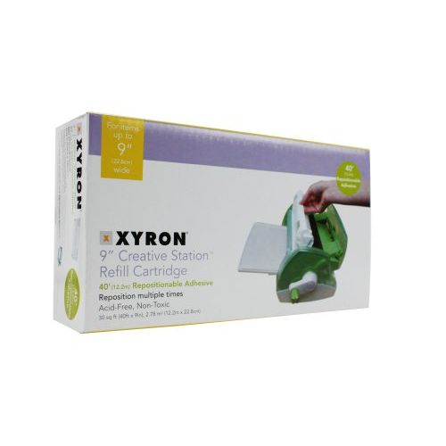 A Xyron 900 Acid Free Repositionable Adhesive Cartridge packaging, showing a green adhesive dispenser and details about the product's specifications.
