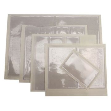 Assorted sizes of 3-1/2" x 4-1/2" Crystal Clear Adhesive Vinyl Pockets displayed in a stack, showing transparent protective covers with adhesive backing.
