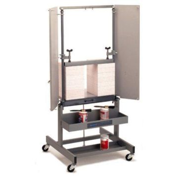 Challenge Paddy Wagon Heavy Duty Padding Press, featuring a sturdy metal frame with a clamping mechanism and shelves for holding padding supplies.