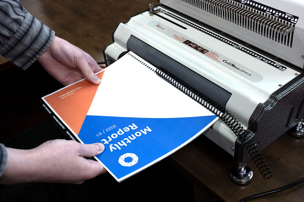 A document being coil bound by the Akiles CoilMac EPI+ Coil Binder