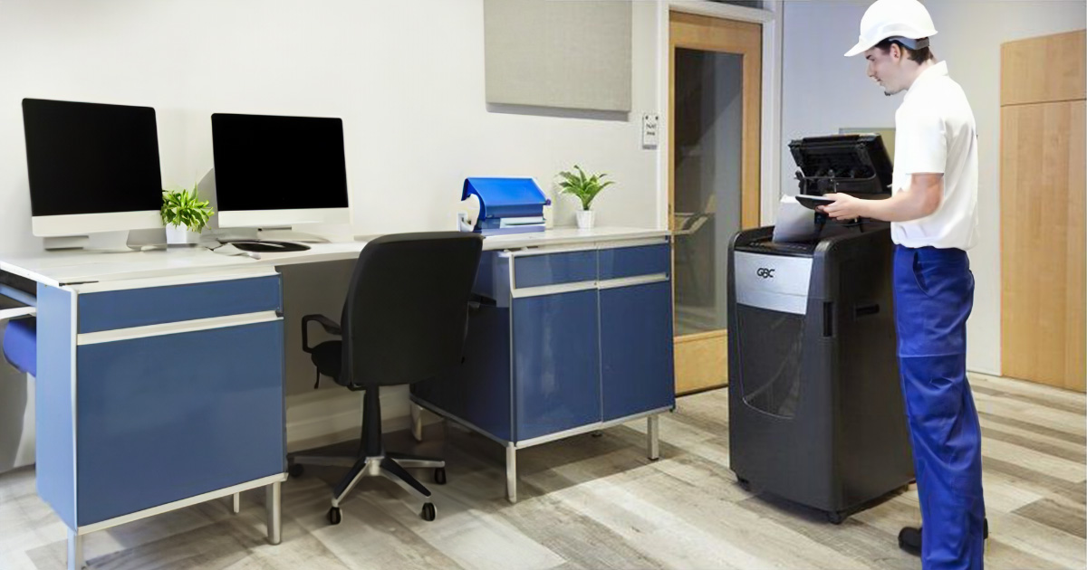 Maintenance personnel conducting routine preventive maintenance on a GBC shredder machine.