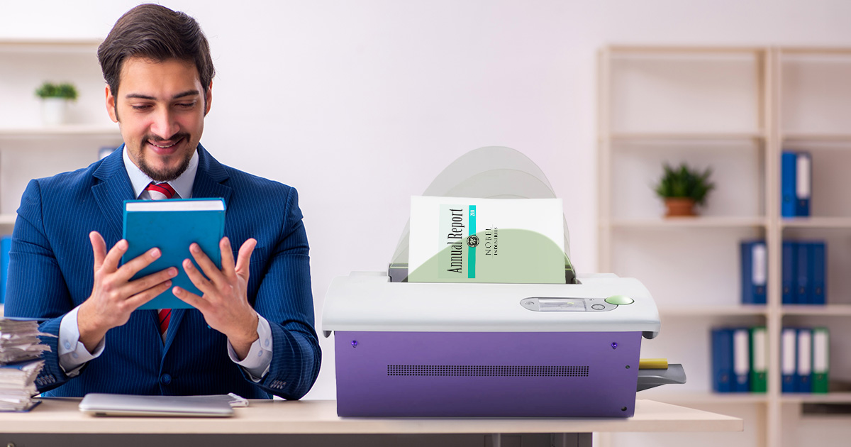 Government employee admiring a newly bound book produced by the Fastback 20 binding machine.