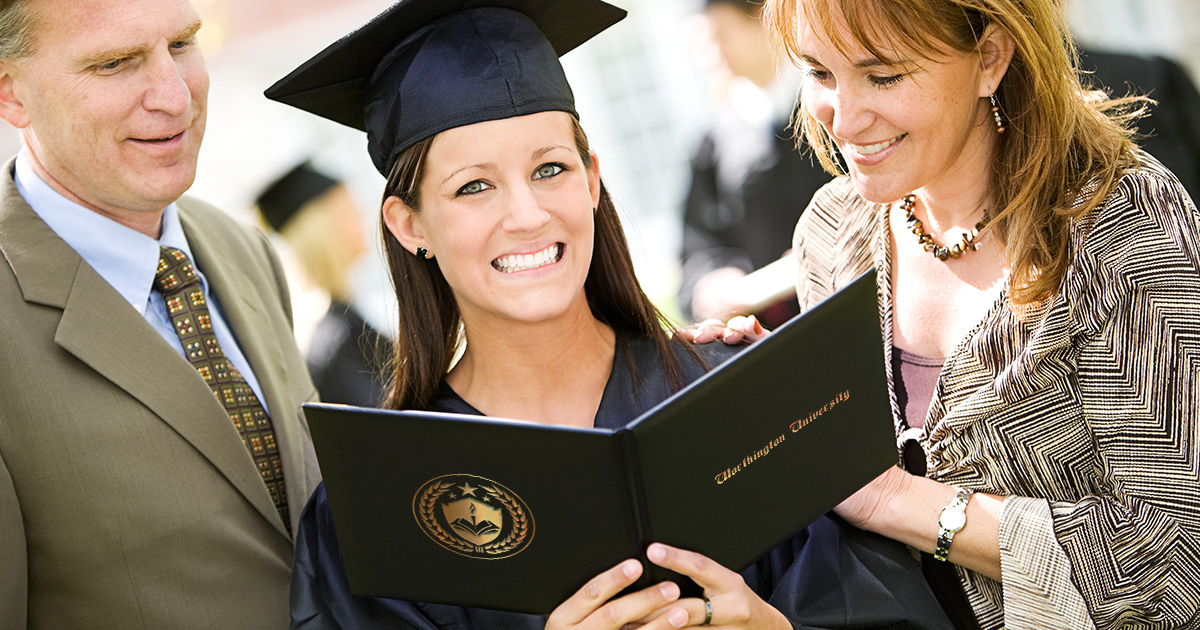 The proud parents reading their newly graduated daughter's diploma presented in a custom certificate holder