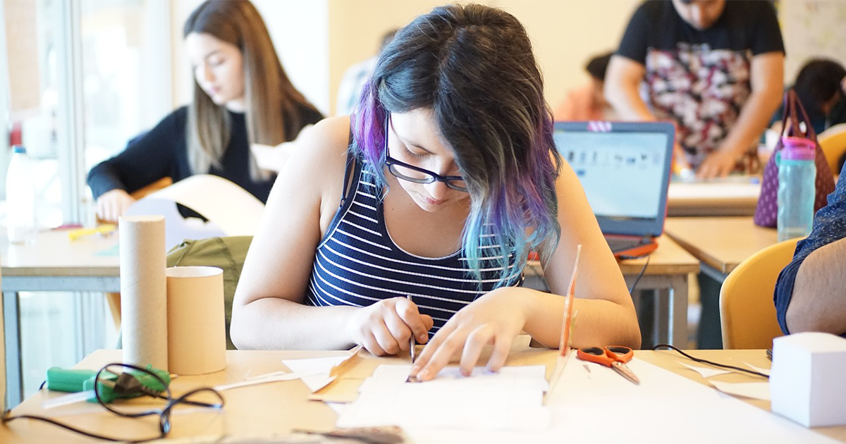 Person cutting paper for book binding