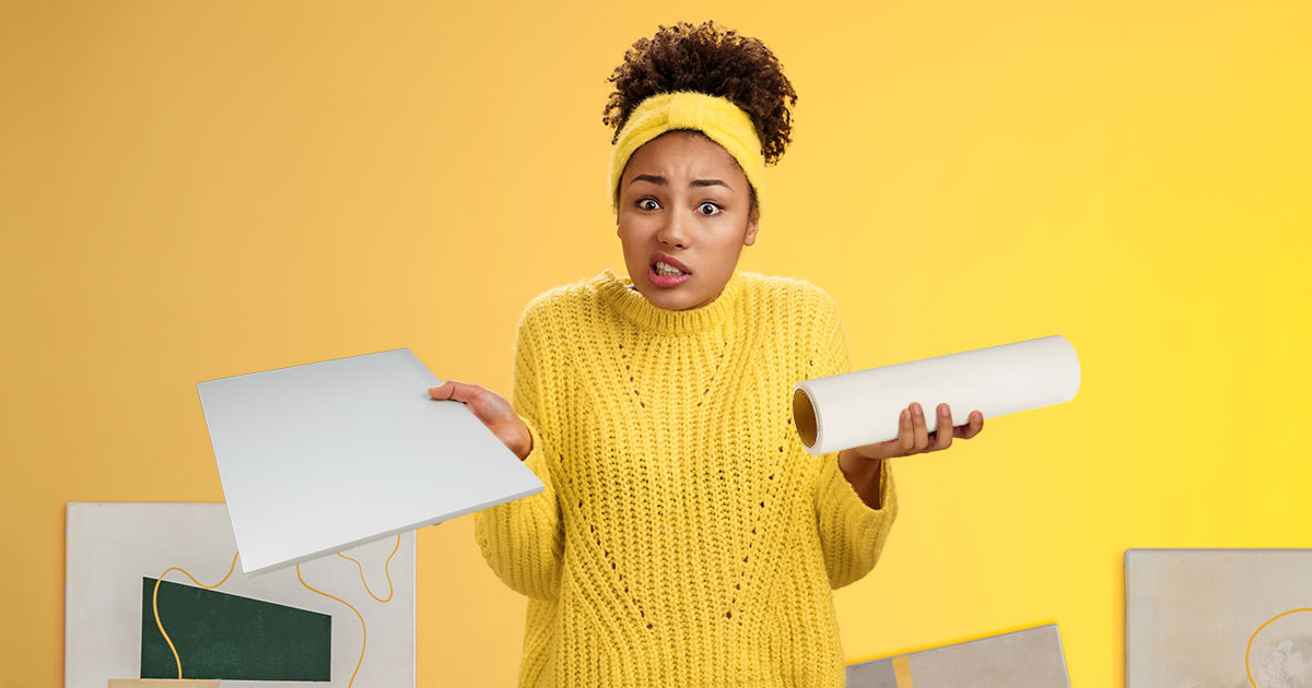 Female in yellow sweater trying to decide which mounting adhesives to use.