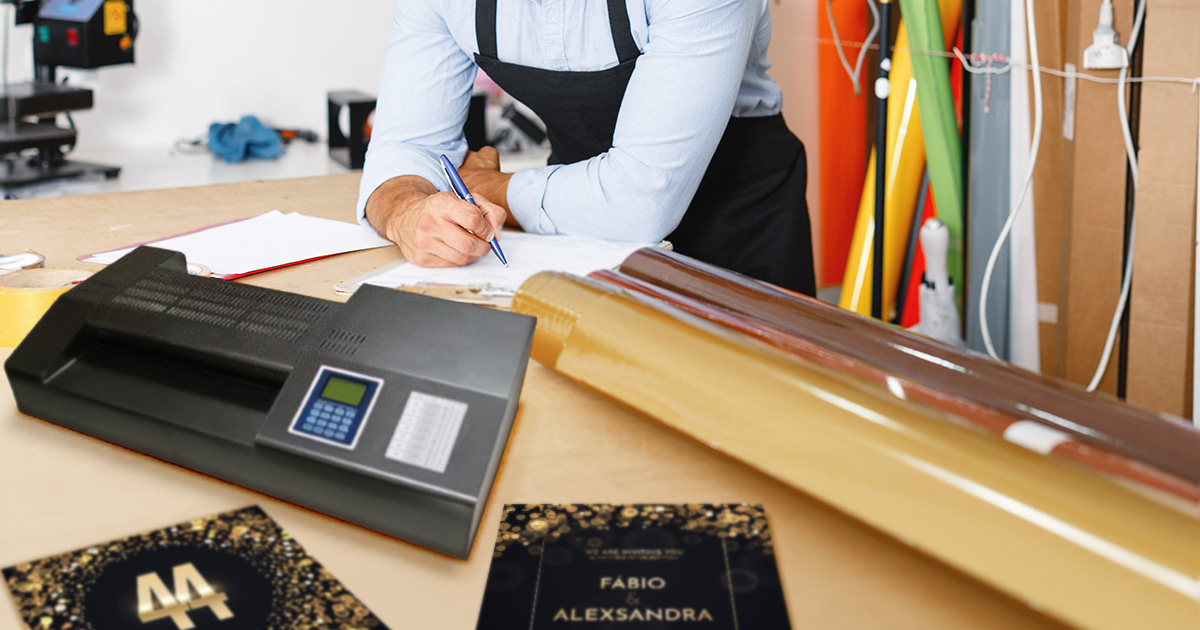 Employee working with projects using a pouch laminator and laminating foil 