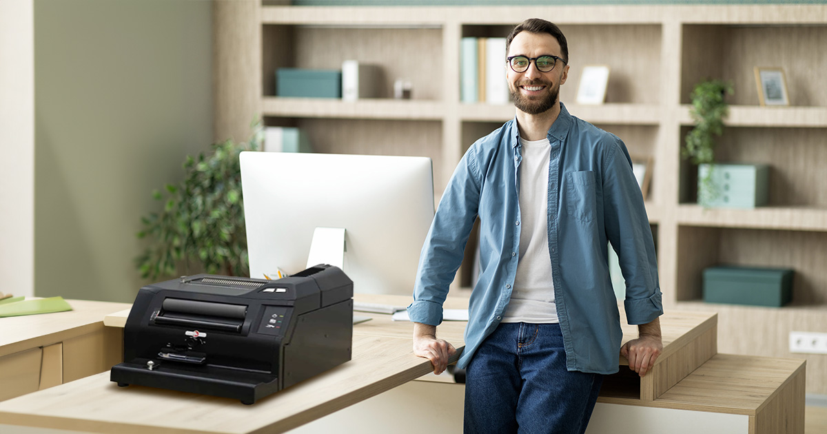 A smiling owner beside his Rhin-O-Tuff 3000 binding system.
