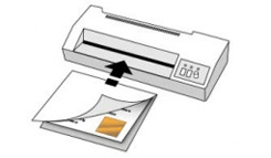 A document being fed into a laminating machine with an arrow indicating the direction of insertion.