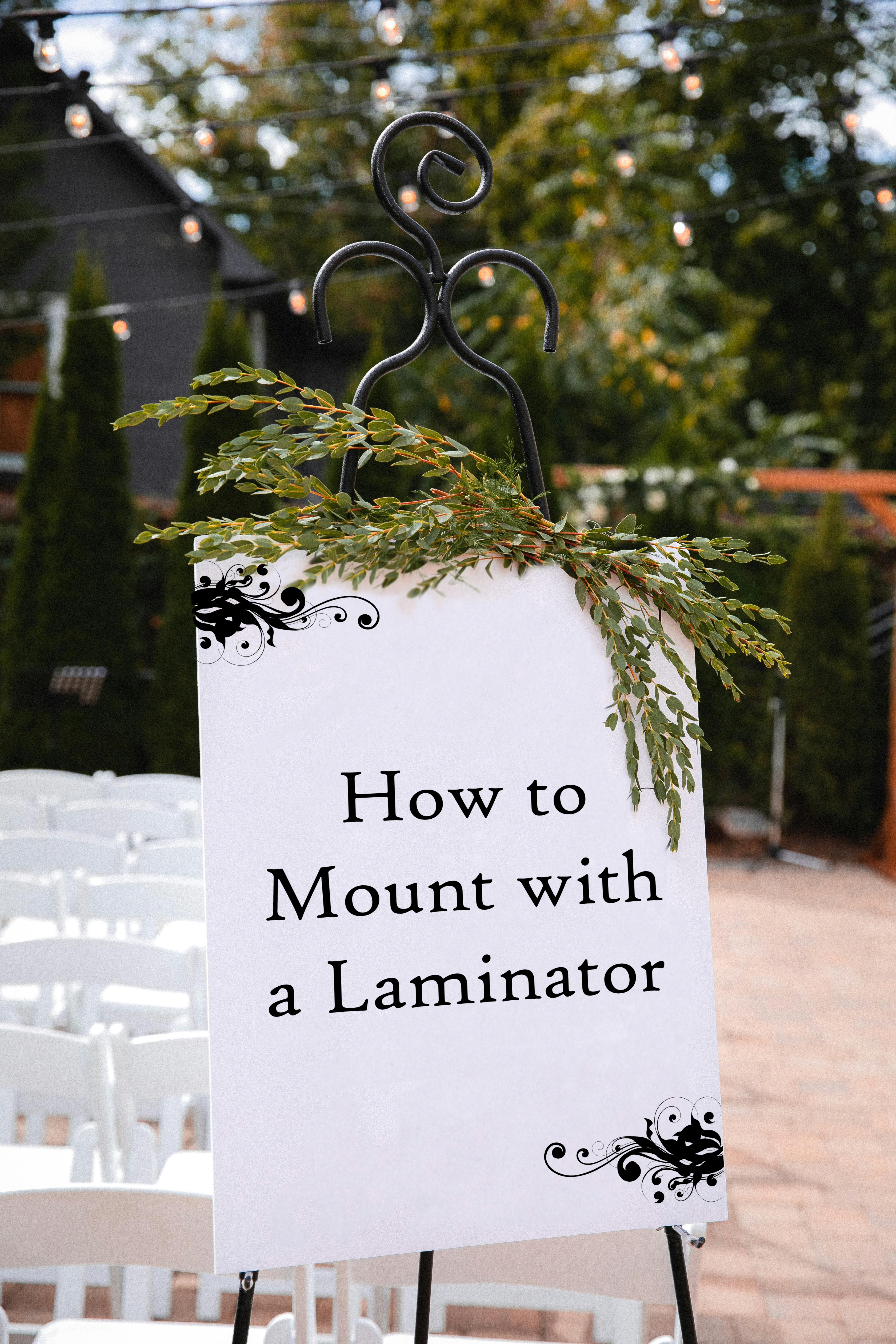 Mounted sign on an stand at an event says - How to Mount with a Laminator
