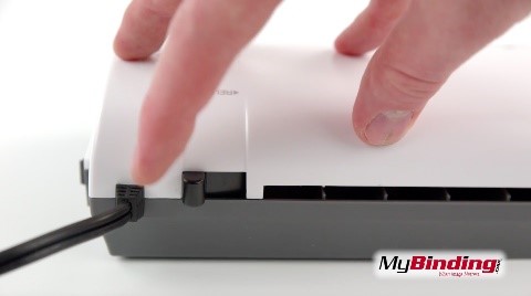 Demonstration of pressing a laminator's release lever