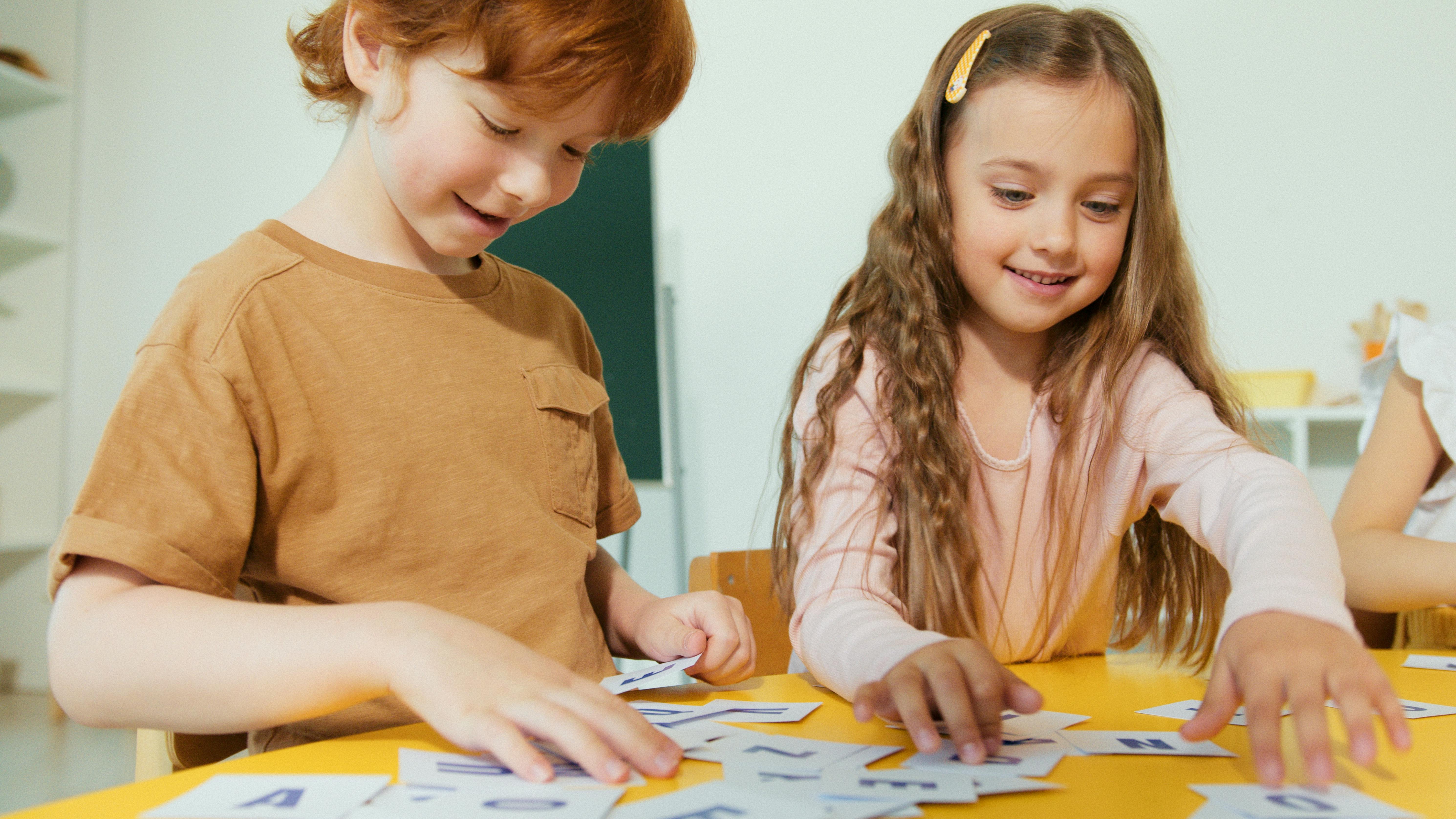 kids playing with laminated letter flashcards